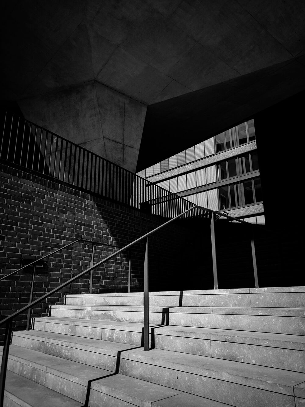Concrete stairway and railing in hard black and white light